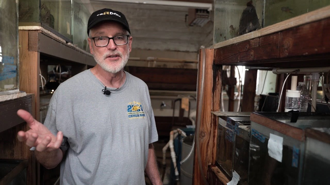 Rich Bireley standing in fish room with wooden stands.